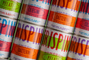 Stacks of colorful cans labeled Taycte Famiglia Crispino Datterini Tomatoes - Sweet Italian Tomatoes from Calabria, featuring bold type and Italian text, highlight the naturally sweet Calabrian tomatoes inside.