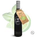 A dark glass bottle of Georgetown Olive Oil Co. Mojito White Balsamic Vinegar stands in front of fresh mint leaves and a lime slice. Crafted in Modena, Italy, this aged white balsamic from Georgetown Olive Oil Co. features a refreshing mojito lime infusion. A brown product tag hangs from the neck, and a “No Alcohol” badge is displayed in the corner.