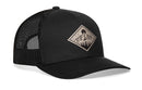 The Haka Hat Diamond Mountain and Trees Trucker Hat is a black outdoors snapback with a mesh back and a front patch featuring a mountain and sun design in beige and black.