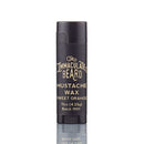 A black tube labeled The Immaculate Beard Dark Shave Soap Protective Lather Sensitive Men, from The Immaculate Beard, stands upright on a white background with a faint reflection below it—perfectly complementing any grooming routine, especially when paired with natural shave soap or beard shaving soap for sensitive skin.