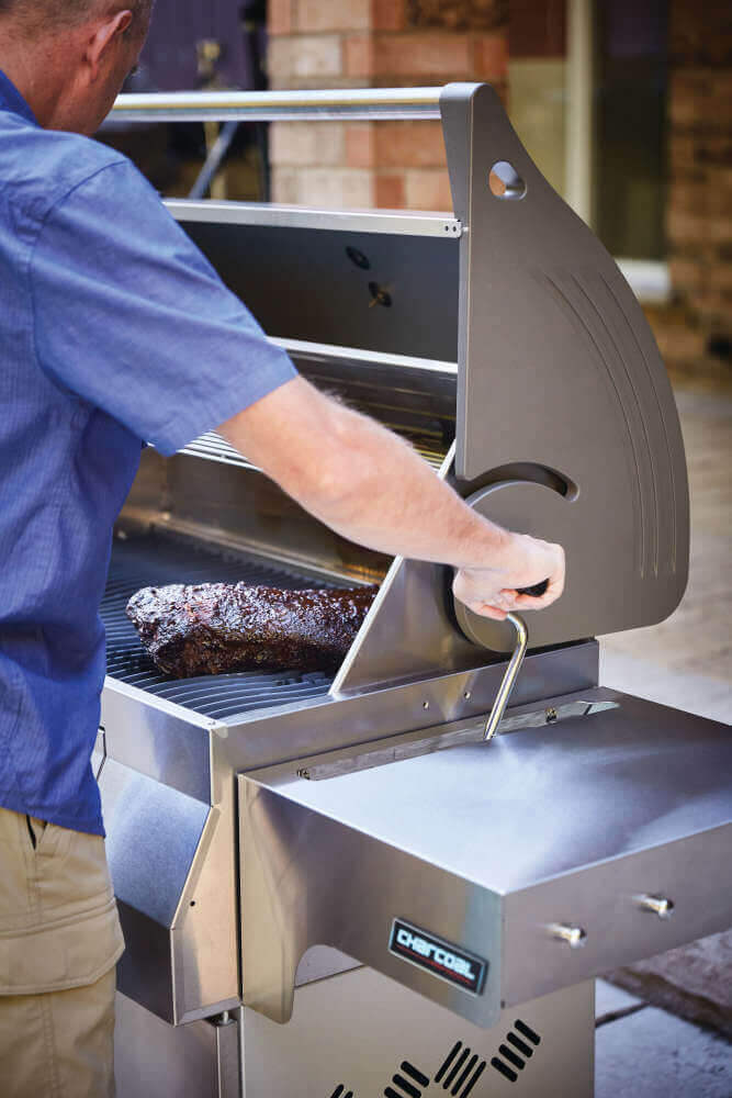 Napoleon PRO605CSS stainless steel charcoal cart grill with rear rotisserie burner and adjustable charcoal tray; view of adjustable feature