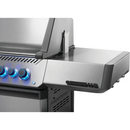 Close-up of the Napoleon Grills Prestige 500 RSIB Stand Alone Gas Grill, featuring three blue-lit knobs, a side burner, advanced infrared side and rear burners, stainless steel finish, clean lines, and a partially open lid for precise grilling.