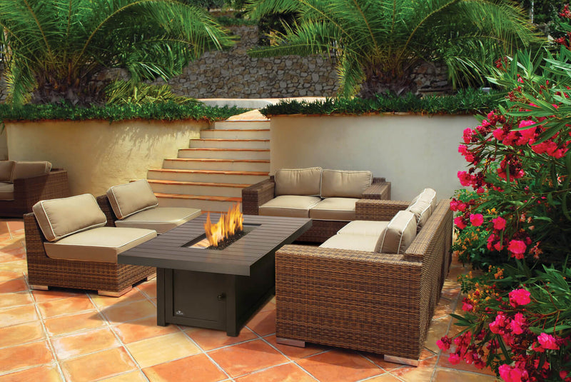 Napoleon St. Tropez Rectangle Fire Pit Table at DDR BBQ Supply on patio with fire lit