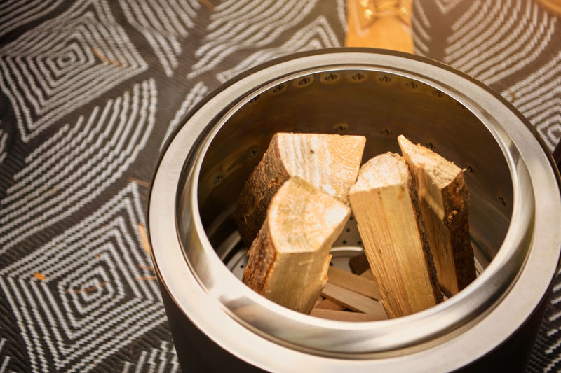 Napoleon Timberwolf Smokeless Portable Fire Pit 18 inch stainless steel at DDR BBQ Supply easy to clean with wood in it. 