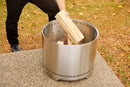 Napoleon Timberwolf Smokeless Portable Fire Pit 18 inch stainless steel at DDR BBQ Supply with wood in it