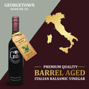 A bottle of Georgetown Olive Oil Co. Neapolitan Herbs Balsamic Vinegar, featuring a Neapolitan herbs tag, sits beside a gold map of Modena, Italy on a split burgundy and beige background. Text emphasizes its premium quality and authentic origin from Georgetown Olive Oil Co.