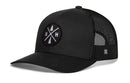 The Haka Hat New Hampshire Trucker Hat is a black and white snapback with a mesh back and an embroidered patch of a tree, axe, and the letters N and H in white. Brand: Haka Hat.