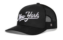 The Haka Hat New York City White Script Trucker Hat features bold white script embroidery, a black mesh back, and a slightly curved brim for style. This black snapback by Haka Hat offers a modern take on classic trucker design.