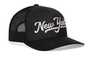 The Haka Hat New York City White Script Trucker Hat is a black snapback featuring bold white New York script embroidery, making it the ideal NYC trucker cap.