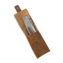 A Messermeister Ojai Folder - 3.75", crafted from N690 super steel, is partially visible in an open brown leather sheath with a button closure, set against a white background—ideal for everyday carry.