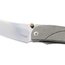 Close-up of the Messermeister Ojai Folder - 3.75", an EDC folding knife with a silver N690 super steel blade, textured gray handle, brass thumb stud, and inscribed with MANIAGO - ITALY and OLDS-INC.