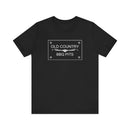 The Old Country BBQ Pits Vintage Logo T-Shirt by Printify features a white rectangular logo with decorative accents—ideal for aspiring pitmasters.