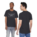 Two men model the Old Country BBQ Pits Vintage Logo T-Shirt by Printify with jeans; one shows the front logo, while the other faces away. Both stand against a white background.