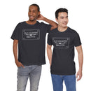 Two men smile side by side in dark Printify Old Country BBQ Pits Vintage Logo T-Shirts. One poses with a hand behind his head; the other stands with a hand in his pocket, proudly displaying their branded shirts.