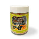 A jar of SALTOPIA Infused Sea Salts "ORANGE YOU TASTY" Orange & Garlic Salt features a green label with orange slices, garlic cloves, and a white lid. Enjoy vibrant citrus-garlic flavor in every sprinkle.