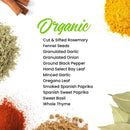 Here’s a rewritten version using your product data: Display of The Spice Lab Organic Spice Set—12 USDA certified organic spices, each in a branded jar with green “Organic” labeling, artfully arranged among vibrant herb and spice powders in yellow, orange, and green hues with bay leaves on a clean white background.