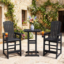 Two DirectDeals Outdoor Bar Stool 29″ Height with Backrest and Armrests in black sit beside a matching round table with a vase of flowers on a stone patio next to a vine-covered stone building.
