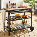 The DirectDeals Outdoor Dining Cart with BBQ Grill and Folding Side Panel is a black cart on a wooden patio, holding wine, beer, glasses, sauces, grilled food, and a towel hanging on the side.