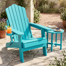 The DirectDeals Folding Adirondack Chair with Adjustable Backrest & Cup Holder sits beside a matching table with dessert on a sunny patio, surrounded by potted plants and stone tiles.