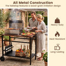 A man and woman grill food on the DirectDeals Outdoor Grill Cart with Stainless Steel Top and Storage, featuring utensils, wine bottles, a durable build, and a heat-resistant wood-grain style tabletop.