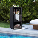 The DirectDeals Outdoor Storage Cabinet Patio Wicker Organizer with Drawer by the pool stores liquor bottles, wine glasses, towels, a basket, and a flower tray amid lush greenery.
