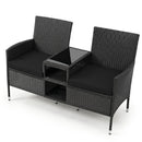 The DirectDeals Outdoor Wicker Loveseat with Built-in Glass Side Table features two seats, black cushions, a central glass side table, and lower open storage shelves for stylish and convenient outdoor seating.