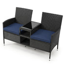 The DirectDeals Outdoor Wicker Loveseat with Built-in Glass Side Table features navy blue cushions, a center glass table, and under-seat storage for stylish and practical outdoor seating.