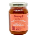 A jar of Powerful Pepper Company’s Peach Fatalii Jam featuring a pink label that highlights its blend of Georgia peaches and Fatalii pepper. The jam inside is orange, and the jar is topped with a silver metal lid.
