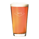 A Pint Glasses - Set of 4: The Diamond filled with amber beer and topped with foam, featuring a diamond-shaped engraving that reads SMITH.