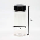 The Spice Lab 12 Pack Plastic Shaker Jars by The Spice Lab are featured in the image, showcasing a clear plastic jar with a black lid—ideal for storing spices and organizing seasonings. Two arrows highlight the jar’s dimensions: 5 inches tall and 2 inches wide. The background is plain white.
