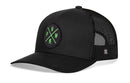 The Haka Hat PNW Bigfoot Trucker Hat by Haka Hat is a black snapback with a mesh back, curved brim, and structured front. It features a round patch with green “P,” “N,” “W,” and “R” letters for a classic Pacific Northwest look.