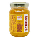 A glass jar with a gold lid contains a yellow sauce labeled "Georgia Grown." The ingredients listed are sugar, pineapple, pectin, and Scotch bonnet peppers. A barcode and nutrition facts are also visible. This Caribbean-inspired jam from the Powerful Pepper Company highlights the bold flavors of its Pineapple Scotch Bonnett Chili Jam, offering a sweet heat reminiscent of Freeport Orange Scotch Bonnet varieties.