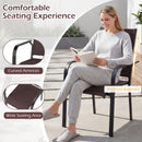 Woman in grey loungewear reads on a Patio Dining Chairs Set of 2/4/6 Stackable Outdoor Armchairs by DirectDeals, featuring curved armrests, wide seat, breathable mesh seating, and inclined backrest amid potted plants.