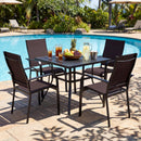 A black table with DirectDeals Patio Dining Chairs Set of 2/4/6 Stackable Outdoor Armchairs sits poolside, surrounded by drinks, lemonade, and fruit amid lush greenery and lounge chairs.
