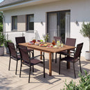 A modern patio next to a house features a wooden dining table, drinks, plates of fruit, and the DirectDeals Patio Dining Chairs Set of 2/4/6 Stackable Outdoor Armchairs.