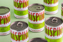 Several cans of Taycte Famiglia Crispino Italian Whole Peeled Tomatoes — Calabrian Grown are arranged on a light green surface. The cans, branded Taycte, feature white labels with green, red, and yellow text. Some cans are open, revealing authentic Calabrian-grown Italian tomatoes—ideal for crafting a rich pizza sauce—while others remain unopened.