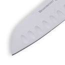 Close-up of the Messermeister Petite Messer Red Kullens Santoku Knife - 5" blade, showing distinctive kullens grooves and the partially visible Messermeister brand name. The high-carbon steel blade is set against a white background.