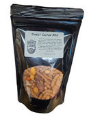 DDR BBQ Supply Manly Cans Sweet Cajun Mix snack pouch with a clear window showing savory nuts and sesame sticks