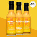 Three bottles of Bravado Spice Co Pineapple & Habanero Hot Sauce are displayed on a yellow background, with a “Most Popular” badge in the top right corner.