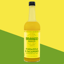 A bottle of Bravado Spice Pineapple & Jalapeño Margarita Mixer from Bravado Spice, featuring a yellow label, is set against a yellow and green diagonal background.