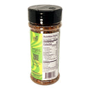 A clear jar of Powerful Pepper Company’s Powerful Pepper Flakes with a green label featuring chili peppers and a QR code, nutrition facts, and topped with a black cap reveals spicy pepper flakes inside.