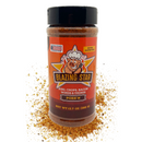 A bottle of Blazing Star BBQ's Pork'n Rub and Seasoning stands upright, surrounded by a dusting of its spice blend. The label features a smiling pig logo and highlights its use for ribs, chops, bacon, wings & more—making it an award-winning BBQ seasoning or pork rub. Net weight: 13.7 oz (388 g).
