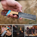 A hand holds the Texan Knives Custom Handmade Bull Cutter with a Damascus steel blade and wooden handle; below are shots of the knife on its leather sheath, someone cooking over a fire, and sliced steak on a cutting board.