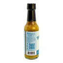 A bottle of Powerful Pepper Company’s Serrano Pineapple Plantain Hot Sauce, an all-natural hot sauce featuring a blue label with nutritional information, a QR code, and social media icons displayed on a white background.