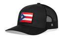 The Haka Hat Puerto Rico Flag Trucker Hat is a black PR snapback featuring a front patch of the Puerto Rican flag, mesh back, and curved brim.