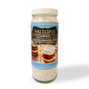 A clear jar of SALTOPIA Infused Sea Salts Pumpkin Cappuccino Infused Sugar, labeled "PUMPKIN TO TALK ABOUT," shows a cappuccino with whipped cream and spices. The net weight is 9 oz.