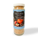 A jar of SALTOPIA Infused Sea Salts Pumpkin Spice Sugar—LOVIN’ MY PUMPKIN, with a blue label featuring pumpkins and spices, contains light brown gourmet infused sugar.