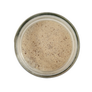 Top view of SALTOPIA Infused Sea Salts’ Pumpkin Cappuccino Infused Sugar: PUMPKIN TO TALK ABOUT—a glass jar of light brown sugar with specks, perfect for cozy pumpkin cappuccinos.