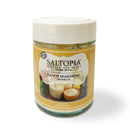 A jar of SALTOPIA Infused Sea Salts labeled Saltopia Ranch Seasoning Low Sodium: SHOOK UP, ideal as a low sodium ranch seasoning for popcorn or snacks, features images of ranch dip, fresh vegetables, and a bowl of salt.