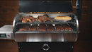 A Recteq RT-700 / RT-680 featuring the Pimp My Grill® Gen2 Slide-Out Rack System - 2 Racks loaded with roasted chickens, ribs, and a pie.